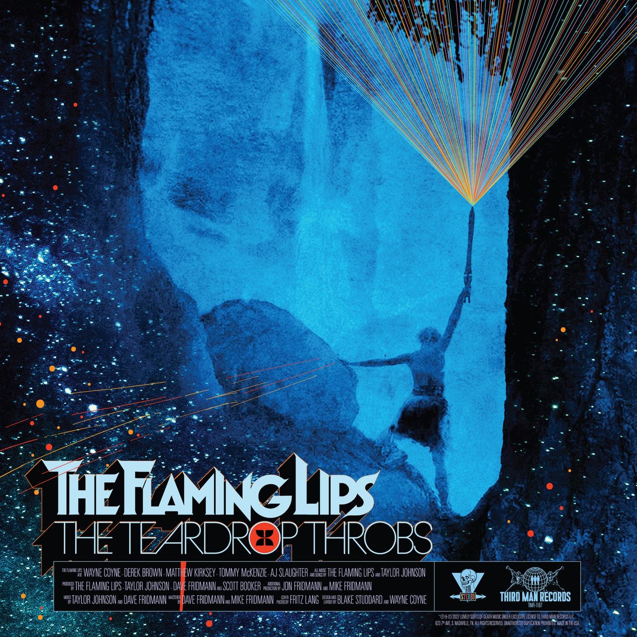 Album cover for The Flaming Lips' The Teardrop Throbs featuring a silhouette raising a sword with colorful light beams.